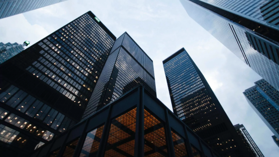 A view looking up at high-rise buildings in a downtown area.